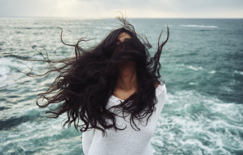 Person with long hair covering their face