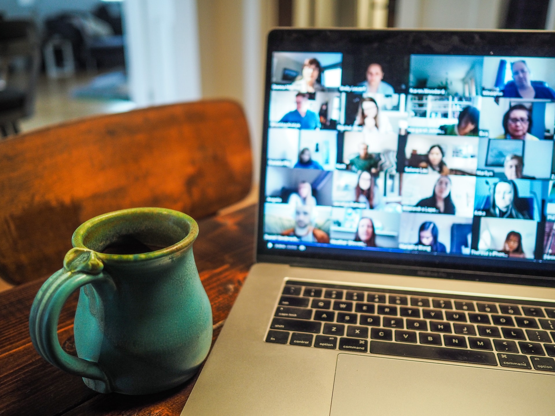 Photograph of a laptop open running a video chat with multiple people